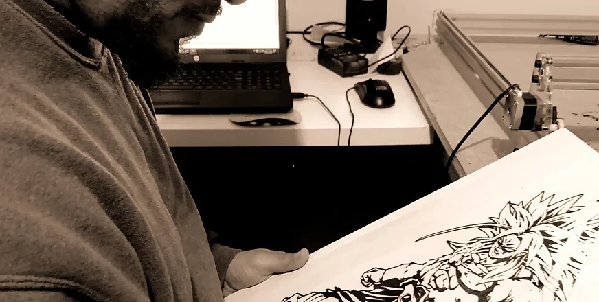 Eulalio Reyes reviewing his anime artwork at his studio desk